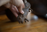 Detailed close-up of collectible African bronze chameleon's textured head and open mouth.