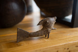 Side profile of a vintage African bronze fish with rustic, handmade textures.