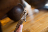 Close-up on the aged bronze patina and etched details on the head of a vintage fish.