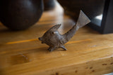 Vintage African bronze fish with a textured, handmade body and aged patina.