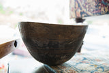 Aged dark wood texture of the vintage African wooden bowl with carved horizontal lines.