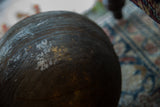 Dark, aged wood surface of the vintage African bowl with carved rings and pale patina.
