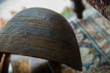 Angled close-up of vintage African wooden bowl, revealing dark wood and etched lines.