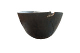 Handmade dark brown African wooden bowl with early 20th century character and visible metal repair.