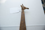 Profile view of the vintage bronze giraffe's head with aged surface patina.