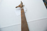 Detail of the sculpted head and patterned neck of a vintage African bronze giraffe.