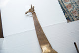 Head and neck of a vintage African bronze giraffe showing hand-etched patterns.