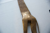 Close-up of the hand-etched crosshatch patterns on the vintage bronze giraffe's back.
