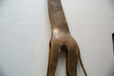 Close-up of the hand-worked texture and aged patina on the bronze giraffe sculpture's back.