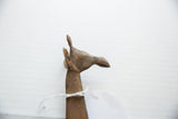 Detailed profile view of the vintage bronze giraffe's sculpted head and horns.