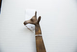 Side profile of the vintage bronze giraffe's head, showing its textured, aged patina.