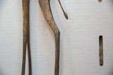 Aged patina on the slender bronze alloy legs and textured tail of the vintage giraffe figure.