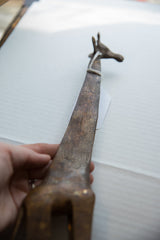 Hand-etched patterns and aged bronze finish on the neck of a vintage African giraffe figure.