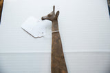 Detailed view of a vintage bronze giraffe's head highlighting its aged, rustic patina.