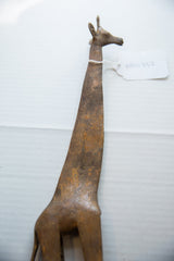 Overhead view of the vintage bronze giraffe's long, textured neck and head.