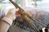 Close-up showing the etched patterns and vintage patina on the handmade bronze giraffe.
