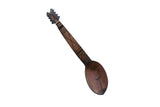 Vintage African wooden spoon with a carved instrument-shaped handle and etched geometric designs.