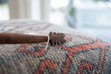 Hand-carved notches and a visible age crack on the vintage wooden spoon.