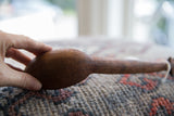 A close-up view of the smooth, rounded bowl of the vintage African wooden spoon.
