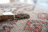 Close-up of the hand-carved, instrument-shaped head of the vintage African spoon.