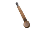 Vintage hand-carved African wooden spoon with a long flat handle, dark pommel, and deep bowl.
