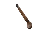 Vintage handmade African wooden spoon with a long handle and dark, aged patina.