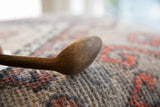 Side profile showing the deep, hand-carved bowl of the vintage wooden spoon.