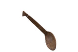 Vintage African wooden spoon with a hand-carved texture and rich, dark patina.