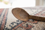 Aged wood grain and hand-carved character on the vintage African spoon bowl.