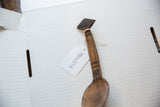 Vintage African wooden spoon shown with its handwritten inventory tag.