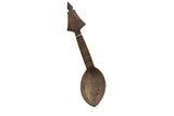 Handmade vintage African wooden spoon with an arrow-shaped handle and carved geometric patterns.