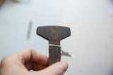 Incised geometric pattern and rich dark wood grain of a vintage African spoon.