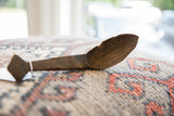 Time-worn texture and carved details of the vintage handmade wooden spoon.