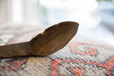 Close-up showing the aged patina and character on the wooden spoon bowl.