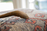 Close-up on the aged, hand-carved character of the vintage wooden spoon bowl.