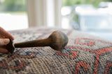 Side view of the handmade vintage African spoon showing its rustic, timeworn character.