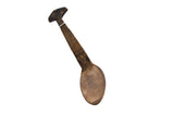 Vintage handmade African wooden spoon with a dark, weathered patina and T-shaped handle.