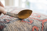 Detail of the hand-carved bowl and etched handle on the vintage African spoon.