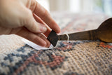 Close-up showing the dark wood and carving on the vintage spoon's handle.