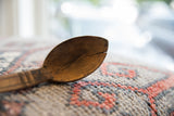 Aged bowl of a vintage African spoon showing rich texture and a characteristic crack.