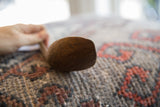 Aged wood grain and surface character on the end of the handmade African spoon.