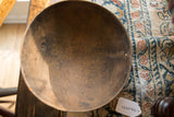 Aged, textured interior of a vintage wooden bowl viewed from above, highlighting a natural crack.