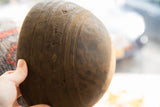 Exterior detail of a vintage wooden bowl with incised linear and geometric carvings.