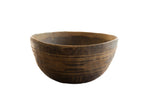 Vintage African wooden bowl with a dark, rustic finish and etched geometric bands.