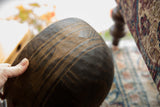 Hand-carved geometric patterns and texture on the dark wooden bowl's exterior.