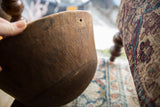 Close view of the worn wood texture and a small hole near the bowl's rim.