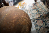 Close-up on the natural imperfections and scratched texture of the vintage wooden bowl.
