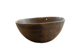 Vintage African wooden bowl with a dark, weathered patina and etched geometric details.