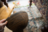 Vintage African wooden bowl with hand-carved line patterns and a chipped edge.