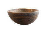 Vintage handmade African wooden bowl with a dark, weathered finish and etched patterns.